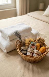 een mand met eten en handdoeken op een bed bij Bois Émeraude in Aix-les-Bains