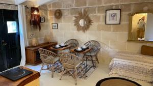 a room with three tables and chairs and a mirror at La Casa Menorca in Ferreries