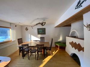 a dining room with a table and chairs at Krumm und Schief Appartments in Brunau