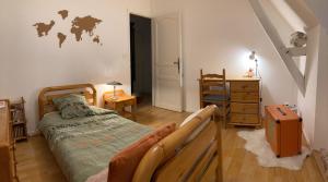 a bedroom with a bed and a dresser in it at Prés de l'aeroport in Ossun