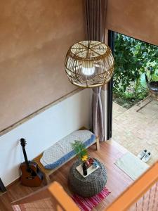 a living room with a rattan lamp and a table at Samstay Đà Lạt in Ấp Ða Lợi