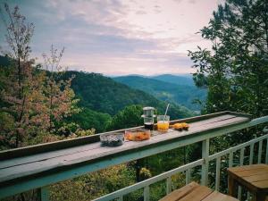 a table with food and drinks on top of a balcony at Samstay Đà Lạt in Ấp Ða Lợi