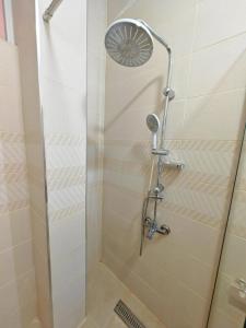 a shower with a shower head in a bathroom at I cloud Petra hostel in Wadi Musa