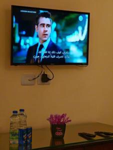 a flat screen tv hanging on a wall at I cloud Petra hostel in Wadi Musa