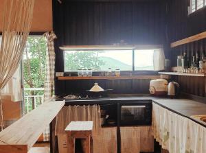 a kitchen with a counter and a window in it at Samstay Đà Lạt in Ấp Ða Lợi