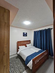 En eller flere senge i et værelse på Tawa Luxe