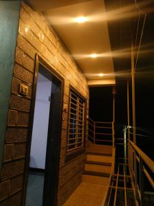 a room with a staircase and a door to a building at Adarsh Niwas in Malvan