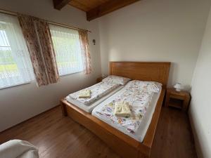 a bedroom with a bed with two baskets on it at Medová chaloupka in Černá Voda