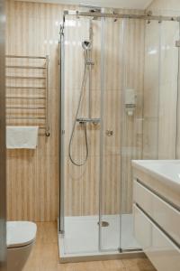 a bathroom with a shower with a toilet and a sink at Soprano Inn Hotel in Pasiky-Zubryts'ki +30 photos