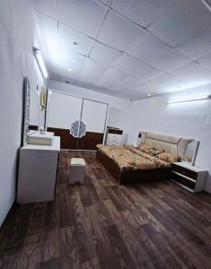 a bedroom with a bed and a desk and a sink at غرفه مفروشه in Mogayra