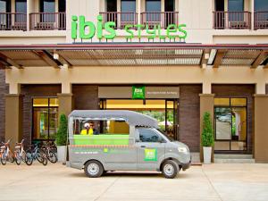 a small van parked in front of a building at ibis Styles Krabi Ao Nang in Ao Nang Beach