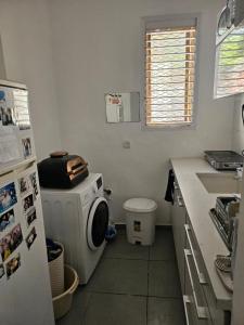 a kitchen with a washing machine and a refrigerator at Ocean view apart in Tel Aviv