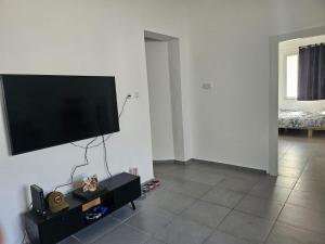 a living room with a flat screen tv on a wall at Ocean view apart in Tel Aviv
