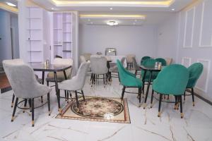 a dining room with tables and green chairs at Ethiopian, Addis Ababa in Addis Ababa