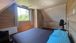 a small bedroom with a bed and a window at Recanto da Natureza in Matinhos +30 photos