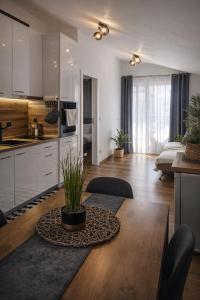 eine Küche und ein Wohnzimmer mit einem Holztisch mit einem Esszimmer in der Unterkunft Charming City Apartment SIYANA - Self Check-in in Panagjurischte