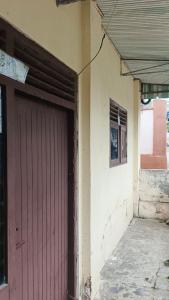 a red door on the side of a building at Denox housee in Geruntang