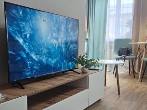 a large flat screen tv sitting on a entertainment center at Глинки 1комн in Semey
