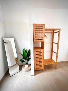 een badkamer met een plank, een spiegel en een plant bij The Cosy Sunset Beach Resort in Thongsala