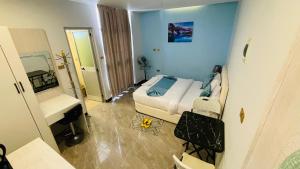 a small bedroom with a bed and a mirror at Solkeb Hotel in Jijiga