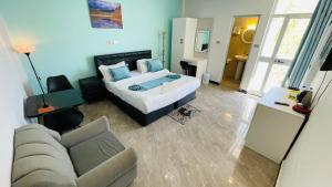a living room with a bed and a couch at Solkeb Hotel in Jijiga