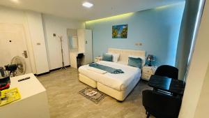 a bedroom with a bed and a desk and a room with a bed at Solkeb Hotel in Jijiga