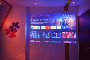 a television screen with a jigsaw puzzle on a wall at Dopamine Hotel in Vung Tau +76 photos