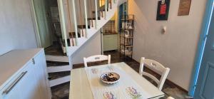 einen Tisch und Stühle in einem Zimmer mit einer Treppe in der Unterkunft ORPHEAS TRADITIONAL HOUSE in Alonnisos Altstadt + 5 Fotos
