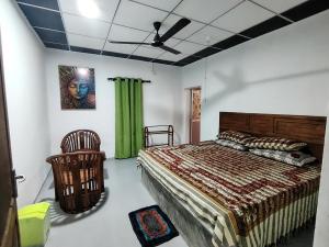 a bedroom with a bed and a green curtain at Villa Hide Out in Busse