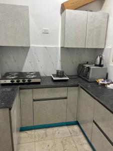 a kitchen with a stove and a counter top at north eye in Noida