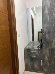 a bathroom with a metal cabinet and a mirror at north eye in Noida