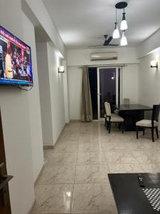 a living room with a flat screen tv on a wall at north eye in Noida