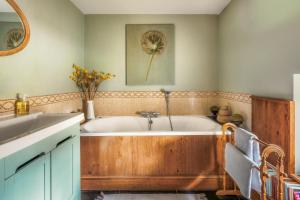 a bathroom with a tub and a sink at Meadow End Barn in Dorstone +41 photos