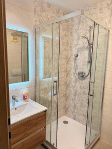 a bathroom with a shower and a sink at Haus Seerose in Seeboden