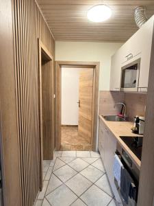 a kitchen with a door leading to a hallway at Haus Seerose in Seeboden