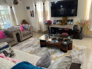 a living room with a couch and a coffee table at Lifeline Homes in Kiserian +19 photos