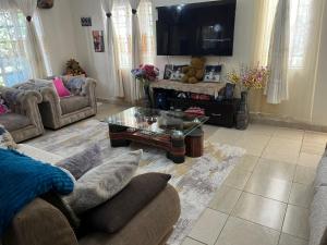 a living room with a couch and a coffee table at Lifeline Homes in Kiserian