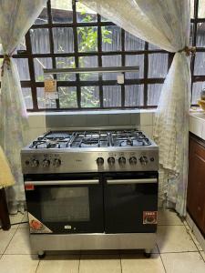 a stove top oven in a kitchen with a window at Lifeline Homes in Kiserian