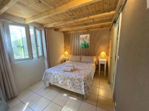 a small bedroom with a bed and a window at Mas de la Vieille Vigne in Argelès-sur-Mer