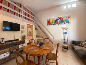 a living room with a table and a couch at Mas de la Vieille Vigne in Argelès-sur-Mer