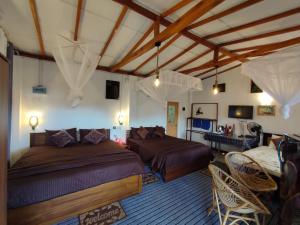 een slaapkamer met 2 bedden en een bank bij Ella Black Bridge View Cottage Sri Lanka in Ella