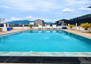 a swimming pool on the roof of a building at The Star House in Patong Beach