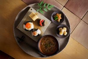 een bord eten met sushi en een kom soep bij 宿 ロイノハコ in Gotsu