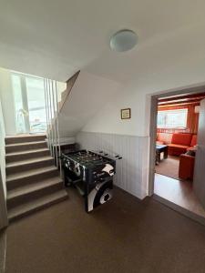 a room with a staircase and a stove in it at House 8 in Liptovský Mikuláš