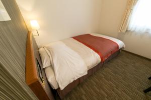 Postel nebo postele na pokoji v ubytování Hotel New Ueno