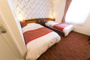 Postel nebo postele na pokoji v ubytování Hotel New Ueno