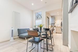 a dining room and living room with a table and chairs at 3BR Sheffield Home - Contractor Friendly with WiFi in Sheffield