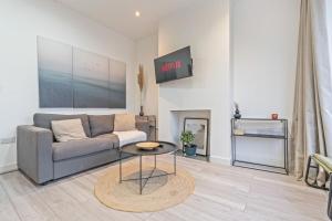 a living room with a couch and a table at 3BR Sheffield Home - Contractor Friendly with WiFi in Sheffield