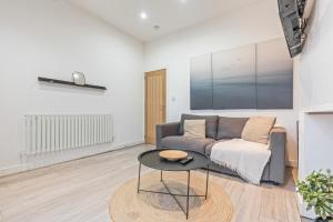 a living room with a couch and a table at 3BR Sheffield Home - Contractor Friendly with WiFi in Sheffield