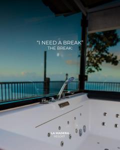 a bath tub with a sign that reads i need a break the breaks at La Madera Resort in Turbul +3 photos